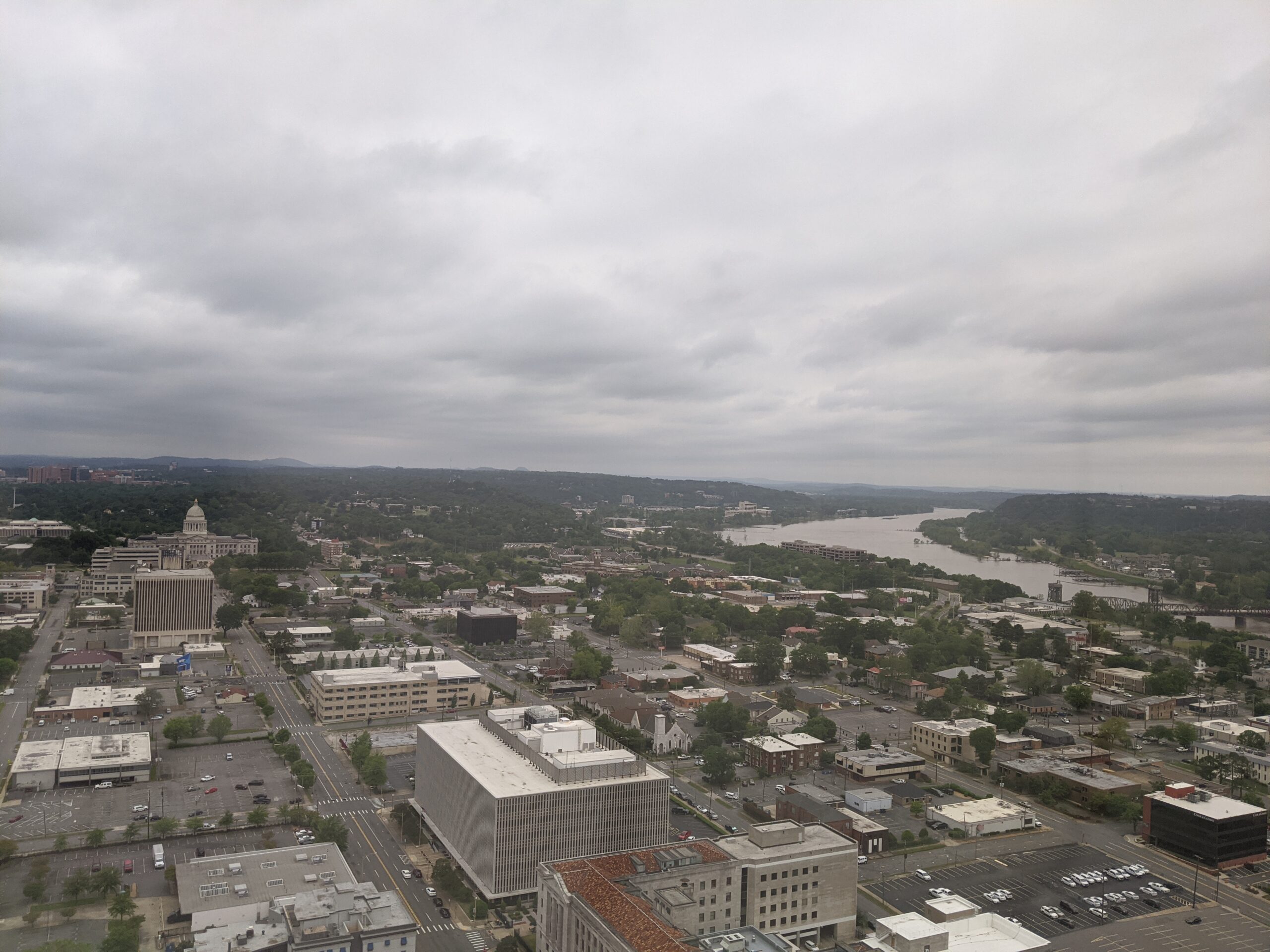 Aerial photo of the city of Little Rock with the state capitol building on the left and the Arkansas river on the right.